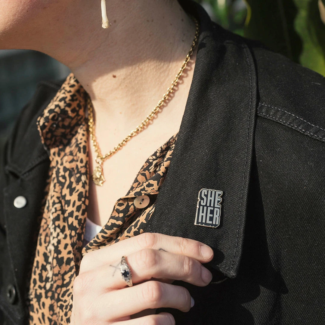 Autostraddle She/Her Pronoun Pin New Merch 2 Autostraddle She/Her Pronoun Pin New Merch